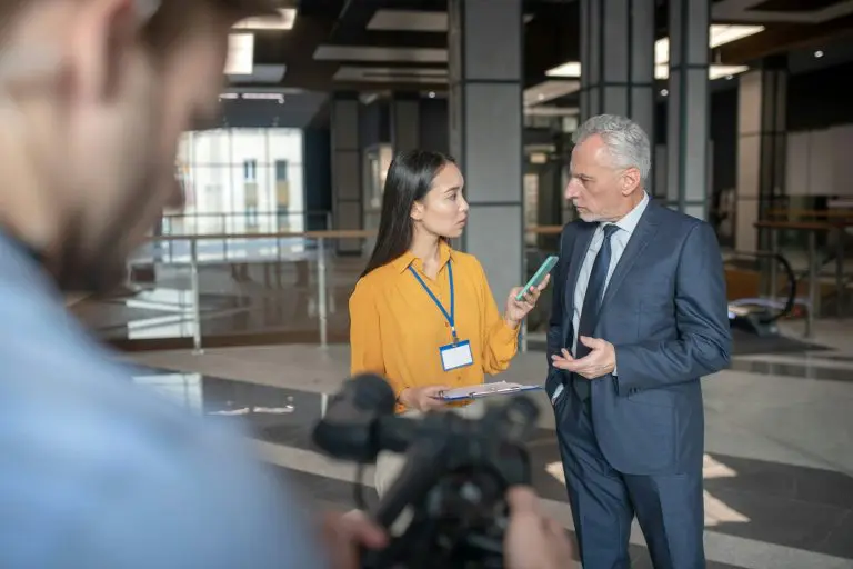 Asian female reporter talking to a famous businessman