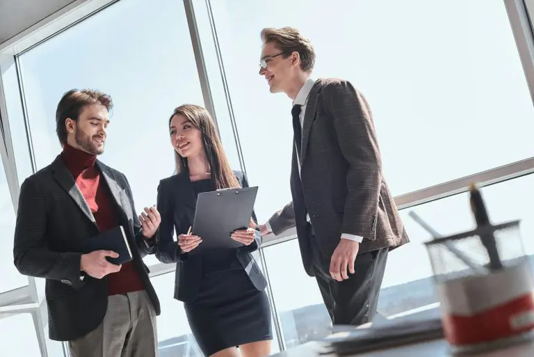 Businesspeople at office working together standing discussing pr