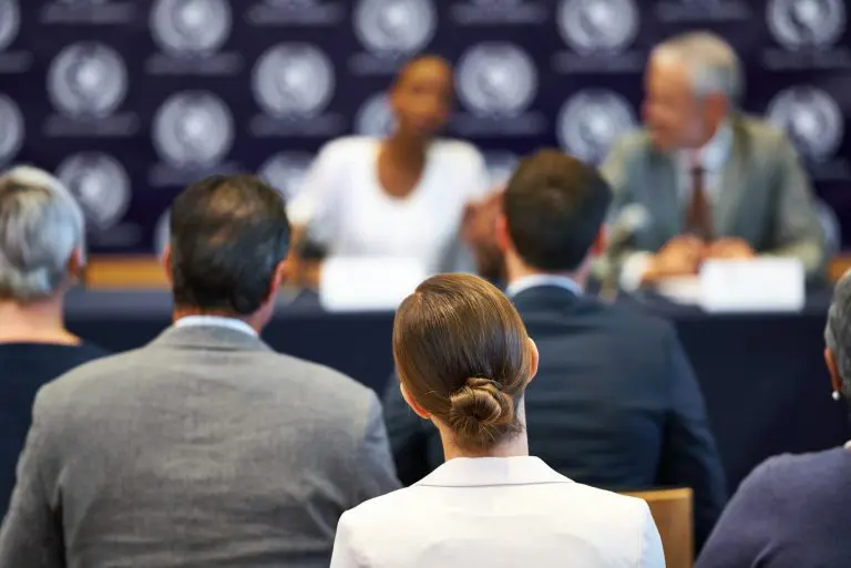 Giving their statement to the public. Shot of a group of businesspeople in a press conference.