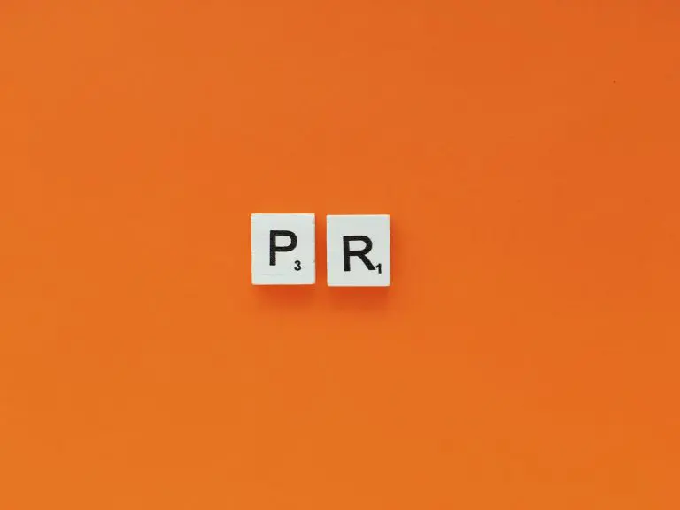 PR, public relations scrabble letters word on a orange background