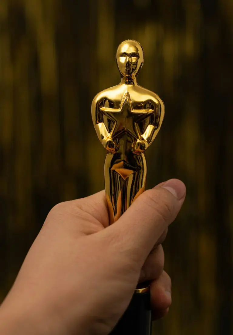 Woman hand holding a plastic Oscar award